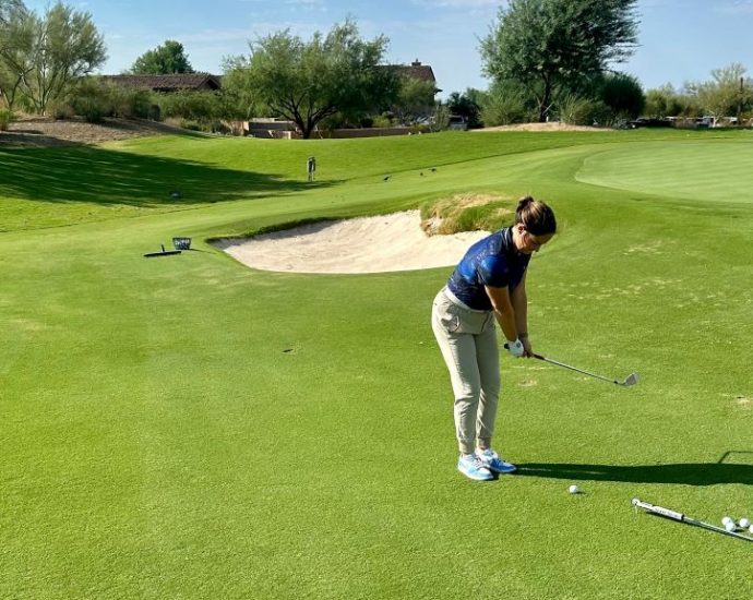 Golfer practicing with golf training aids on a driving range