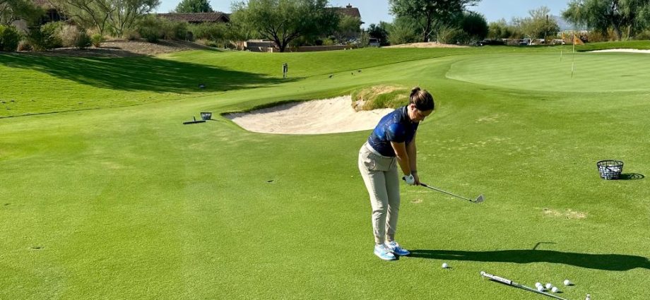 Golfer practicing with golf training aids on a driving range